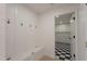 This mudroom includes a bench, coat hooks, and a door to the laundry room at 1720 W Behrend Dr, Phoenix, AZ 85027