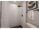 Modern white shower with black hardware and hexagon tile flooring at 1720 W Behrend Dr, Phoenix, AZ 85027