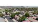 Scenic aerial view of a residential neighborhood with a community pool and mountain views in the background at 1758 E San Xavier Dr, Casa Grande, AZ 85122