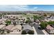 Neighborhood aerial view showcasing well-maintained homes, tree-lined streets, and a community park in the distance at 1758 E San Xavier Dr, Casa Grande, AZ 85122