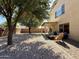 Large backyard with desert landscaping, covered patio, and mature trees at 1758 E San Xavier Dr, Casa Grande, AZ 85122