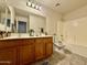 Bathroom with a wood vanity, double sinks, and a tub and shower combination at 1758 E San Xavier Dr, Casa Grande, AZ 85122