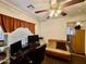 Bedroom/office space features a ceiling fan, tile flooring, and a window providing natural light at 1758 E San Xavier Dr, Casa Grande, AZ 85122
