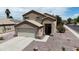 Charming two-story home featuring a neutral color palette, attached garage, and low maintenance desert landscaping at 1758 E San Xavier Dr, Casa Grande, AZ 85122