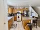 Eat-in kitchen featuring wood cabinets, an island with seating, and stainless steel appliances at 1758 E San Xavier Dr, Casa Grande, AZ 85122