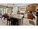 Eat-in kitchen featuring wood cabinets, an island with seating, and stainless steel appliances at 1758 E San Xavier Dr, Casa Grande, AZ 85122