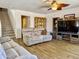 Comfortable living room featuring a ceiling fan, wood look tile flooring, and entertainment center at 1758 E San Xavier Dr, Casa Grande, AZ 85122