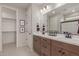 Well-lit bathroom with double sink vanity, modern fixtures, and neutral color palette for a clean, contemporary feel at 18161 W Cielo Grande Ave, Surprise, AZ 85387