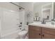 Bright bathroom featuring a shower-tub combination and a stylish vanity with a sink at 18161 W Cielo Grande Ave, Surprise, AZ 85387