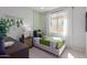 Comfortable bedroom with modern decor, featuring a cozy bed and stylish green accents for a vibrant, youthful atmosphere at 18161 W Cielo Grande Ave, Surprise, AZ 85387