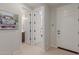 Bright hallway with access to a powder room and other rooms, featuring neutral walls and easy access to other spaces at 18161 W Cielo Grande Ave, Surprise, AZ 85387