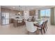 Beautiful kitchen with stainless steel appliances, granite countertops, a kitchen island, and an adjacent dining area at 18161 W Cielo Grande Ave, Surprise, AZ 85387