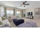 Inviting living room featuring a comfortable sofa, contemporary furnishings, and a sliding glass door leading to the backyard at 18161 W Cielo Grande Ave, Surprise, AZ 85387