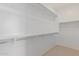 Spacious walk-in closet featuring ample shelving and storage options, offering plenty of room for organization at 18161 W Cielo Grande Ave, Surprise, AZ 85387