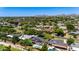 Beautiful aerial shot of a neighborhood with mature trees, diverse homes, and a backdrop of scenic mountains under a clear sky at 1839 E Palo Verde Dr, Phoenix, AZ 85016