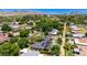 Picturesque aerial view of a neighborhood with lush trees, diverse homes, and stunning mountain views in the background at 1839 E Palo Verde Dr, Phoenix, AZ 85016