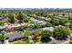 Lush residential area showing diverse single-Gathering homes, mature trees, and a glimpse of community pools in a sunny setting at 1839 E Palo Verde Dr, Phoenix, AZ 85016