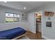 Cozy bedroom with natural light, closet space, and calming blue accents at 1839 E Palo Verde Dr, Phoenix, AZ 85016