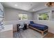 Bright bedroom with view to backyard, neutral walls, and wood floor at 1839 E Palo Verde Dr, Phoenix, AZ 85016