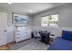 Bedroom with neutral decor, white wainscotting, desk and plush rug at 1839 E Palo Verde Dr, Phoenix, AZ 85016