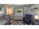 Charming Bedroom with a crib, accent lighting, and a cozy armchair at 1839 E Palo Verde Dr, Phoenix, AZ 85016