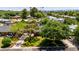 Beautifully landscaped front yard featuring mature trees, lush green lawn, and charming home exterior in a peaceful setting at 1839 E Palo Verde Dr, Phoenix, AZ 85016