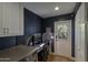 Well-lit laundry room featuring a convenient desk and laundry machines at 1839 E Palo Verde Dr, Phoenix, AZ 85016