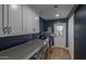 Multifunctional laundry room complete with office area and storage cabinets at 1839 E Palo Verde Dr, Phoenix, AZ 85016