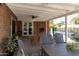 Charming covered patio with brick features, ceiling fan, and backyard view at 1839 E Palo Verde Dr, Phoenix, AZ 85016