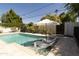 Inviting pool area with lounge chairs, lush landscaping, and a clear blue swimming pool at 1839 E Palo Verde Dr, Phoenix, AZ 85016