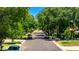 Tree-lined street view with well-maintained lawns and parked cars in a quiet neighborhood at 1839 E Palo Verde Dr, Phoenix, AZ 85016
