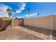 Fenced backyard with low-maintenance gravel landscaping and a gate, offering security and privacy at 1887 E La Donna Dr, Tempe, AZ 85283