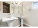 This bathroom features two pedestal sinks and a window for natural light at 1887 E La Donna Dr, Tempe, AZ 85283