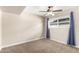 The carpeted bedroom features curtains, a ceiling fan, and a window that provides natural light at 1887 E La Donna Dr, Tempe, AZ 85283