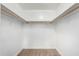 A standard walk-in closet with shelving and a carpeted floor provides ample storage space at 1887 E La Donna Dr, Tempe, AZ 85283