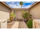 Inviting entryway with a pathway leading to double doors, complemented by palm trees at 1887 E La Donna Dr, Tempe, AZ 85283