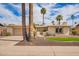 Charming single-story home boasting a well-maintained yard with lush landscaping and palm trees at 1887 E La Donna Dr, Tempe, AZ 85283