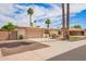 Desirable single-story home with a two-car garage, lush landscaping, and mature palm trees enhancing curb appeal at 1887 E La Donna Dr, Tempe, AZ 85283