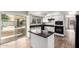 Bright kitchen with wood floors, center island, white cabinetry, and stainless steel appliances at 1887 E La Donna Dr, Tempe, AZ 85283