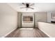 Bright living space with wood floors, a ceiling fan, and a large window at 1887 E La Donna Dr, Tempe, AZ 85283