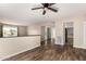 Open-concept living area with wood floors, a ceiling fan, and access to other rooms at 1887 E La Donna Dr, Tempe, AZ 85283