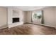 Spacious living room showcasing wood floors, a fireplace, and a bright window at 1887 E La Donna Dr, Tempe, AZ 85283