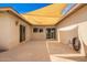 Enclosed patio area featuring a sun shade and sliding glass door access to the home's interior at 1887 E La Donna Dr, Tempe, AZ 85283