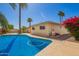 Sparkling blue pool surrounded by lush landscaping, perfect for enjoying sunny days in your private backyard at 1887 E La Donna Dr, Tempe, AZ 85283