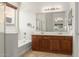 Well-lit bathroom with double vanity, tub, shower, large mirror, and tile flooring at 19319 E Thornton Rd, Queen Creek, AZ 85142