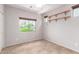 Cozy bedroom with tile flooring, window with blinds, and custom shelving for storage or decor at 19319 E Thornton Rd, Queen Creek, AZ 85142