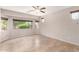 Bright bedroom with neutral walls, tile flooring, and large windows offering outdoor views at 19319 E Thornton Rd, Queen Creek, AZ 85142