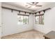 Bright dining room with tile flooring, custom shelving, and natural light from large windows at 19319 E Thornton Rd, Queen Creek, AZ 85142