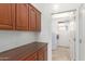 Practical laundry room featuring wooden cabinets, a countertop, and a modern washer and dryer at 19319 E Thornton Rd, Queen Creek, AZ 85142