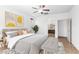 Bright primary bedroom with neutral walls, ceiling fan and carpet connects to the ensuite bathroom at 19319 E Thornton Rd, Queen Creek, AZ 85142